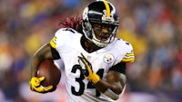 a pittsburgh steelers football player running with the ball